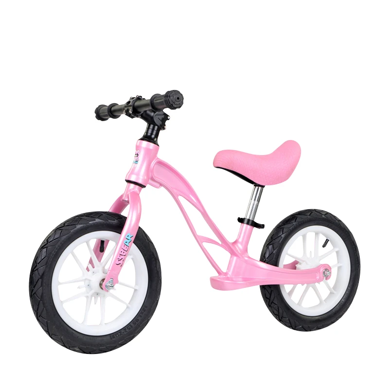 kid riding balance bike